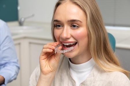 woman getting invisalign braces