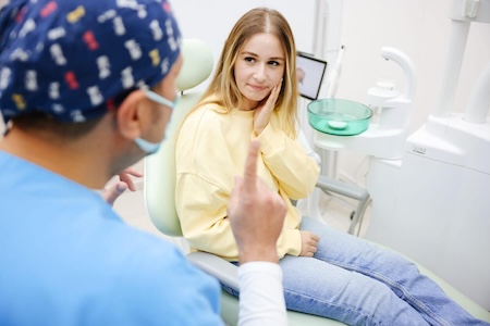 A girl seeking the help of a professional 24-hour emergency dentist for urgent dental care.