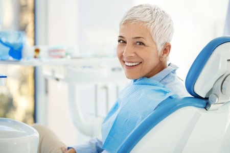 A senior women smiling at after getting a successful gingavitis treatment at the Aliso Creek Dental